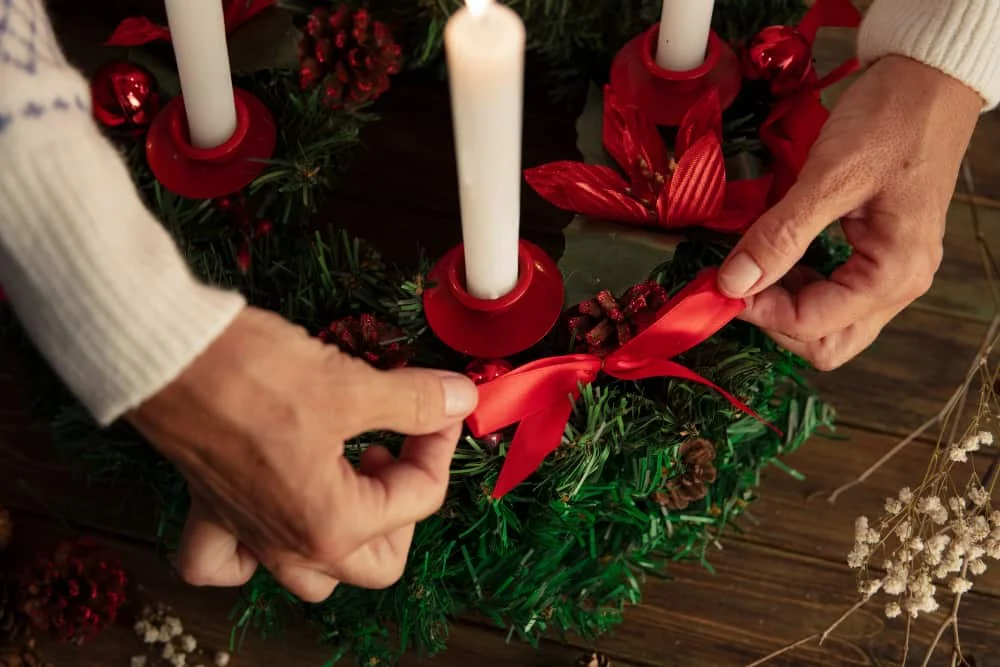 woman assembling holiday themed wreath 2